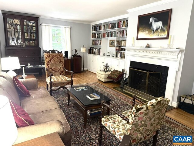 1895 Westview Rd, Charlottesville, VA 22903 - living area featuring wood finished floors, crown molding, a fireplace with flush hearth, and built in shelves