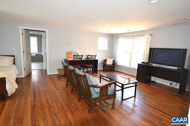 living room with visible vents, wood finished floors, baseboards, and recessed lighting