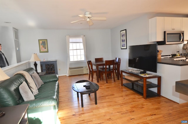 living area featuring a ceiling fan and light wood-style flooring