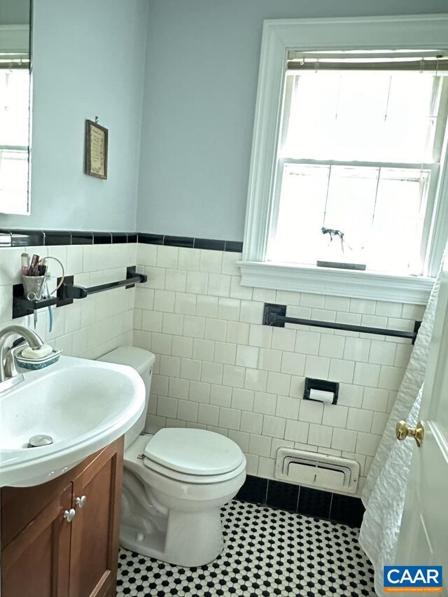 1895 Westview Rd, Charlottesville, VA 22903 - bathroom featuring tile walls, toilet, wainscoting, vanity, and tile patterned floors