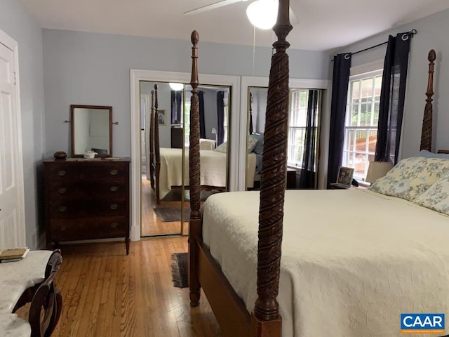 bedroom with light wood-style flooring and a ceiling fan