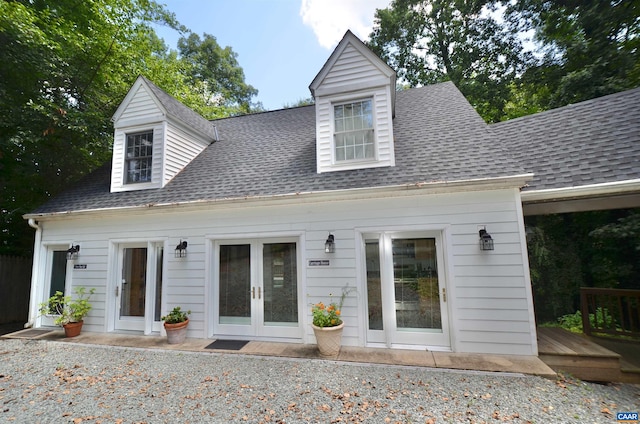 back of house featuring a deck, a shingled roof, and french doors