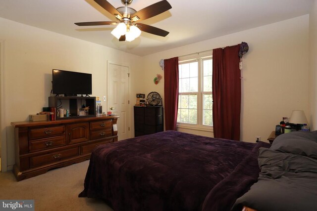 bedroom with light carpet and ceiling fan