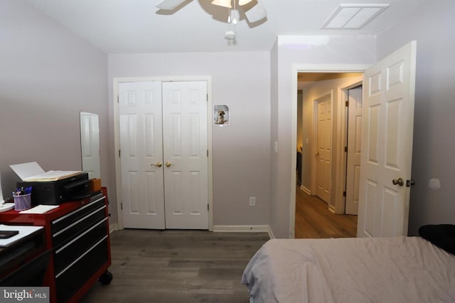 bedroom with dark hardwood / wood-style flooring, a closet, and ceiling fan