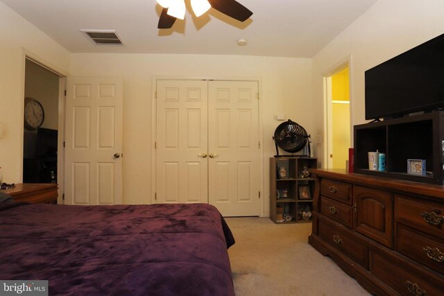 bedroom with light carpet, a closet, and ceiling fan