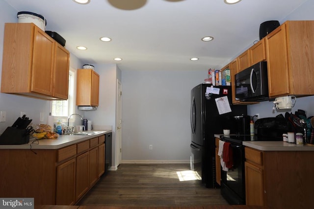 kitchen with black range with electric cooktop, dark hardwood / wood-style flooring, and sink