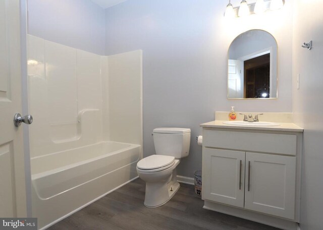 full bathroom with vanity, toilet, tub / shower combination, and hardwood / wood-style floors