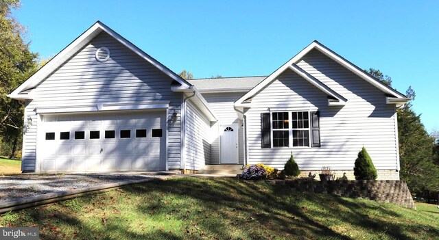 view of front of house with a garage and a front yard