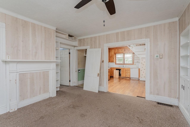 1221 Keezletown Rd, Weyers Cave, VA 24486 - unfurnished bedroom featuring carpet floors, wooden walls, crown molding, a textured ceiling, and a ceiling fan