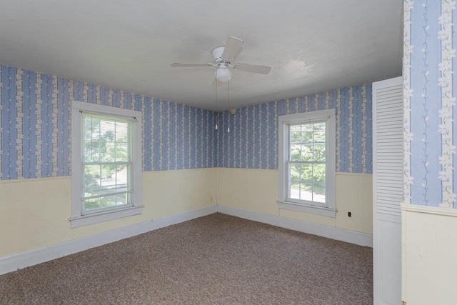 1221 Keezletown Rd, Weyers Cave, VA 24486 - carpeted empty room with a wainscoted wall, wallpapered walls, and a ceiling fan
