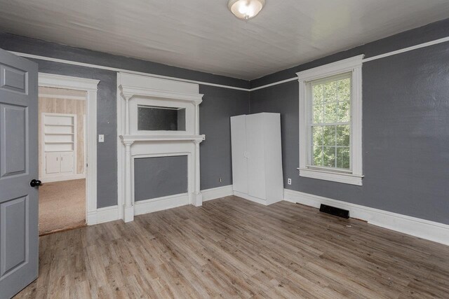 1221 Keezletown Rd, Weyers Cave, VA 24486 - unfurnished living room with wood finished floors and a fireplace