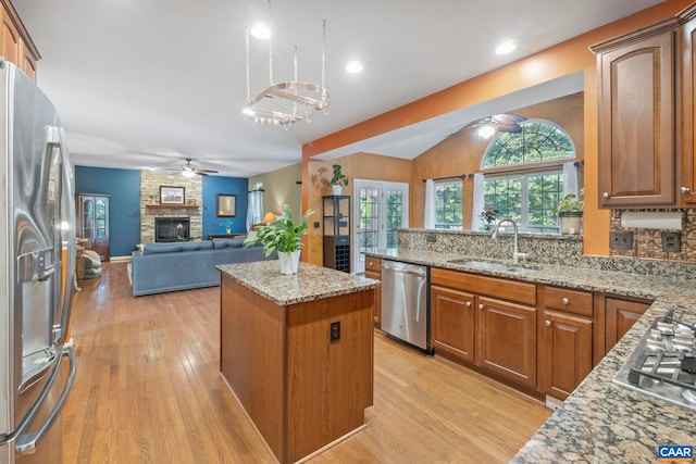 797 Willow Ridge Rd, Troy, VA 22974 - kitchen featuring stainless steel appliances, ceiling fan, light wood-type flooring, a stone fireplace, and lofted ceiling