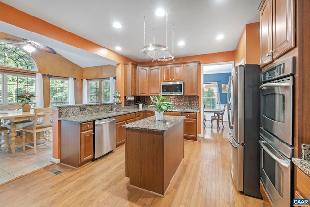 797 Willow Ridge Rd, Troy, VA 22974 - kitchen with appliances with stainless steel finishes, a kitchen island, lofted ceiling, stone counters, and a peninsula
