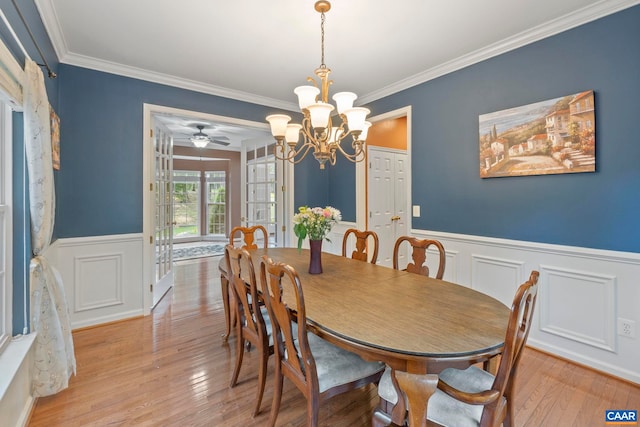 797 Willow Ridge Rd, Troy, VA 22974 - dining space featuring a chandelier, wainscoting, ornamental molding, light wood finished floors, and a decorative wall