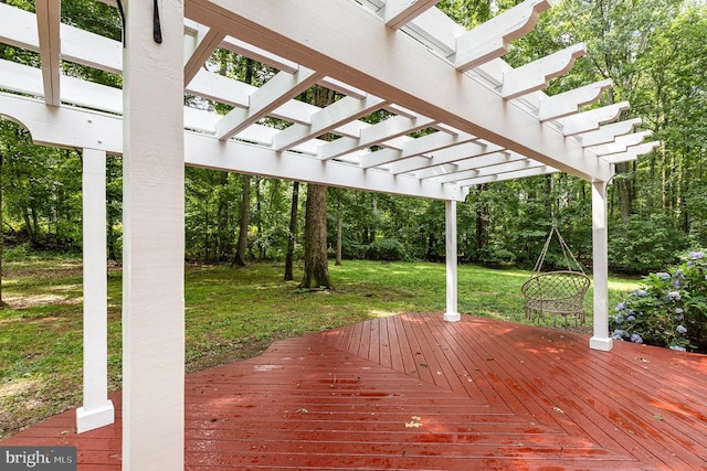  - wooden deck featuring a pergola and a yard