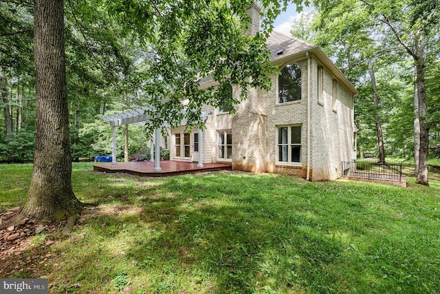  - rear view of house with a pergola, a patio area, a chimney, and brick siding