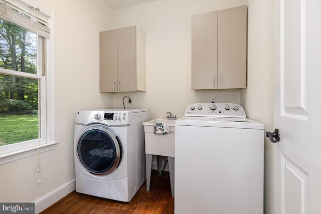  - laundry area with cabinet space, washing machine and dryer, and dark wood finished floors