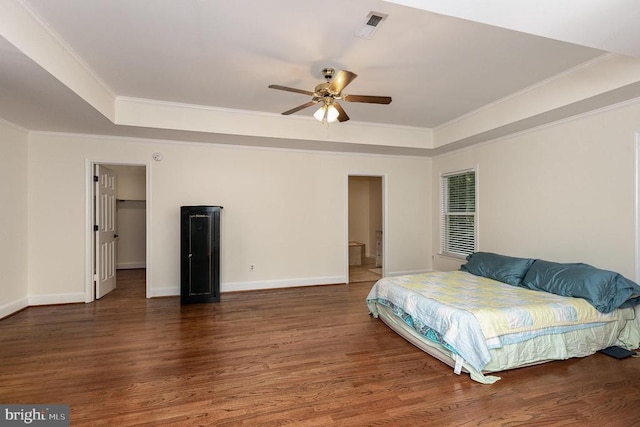  - bedroom featuring a raised ceiling, ornamental molding, wood finished floors, and ceiling fan