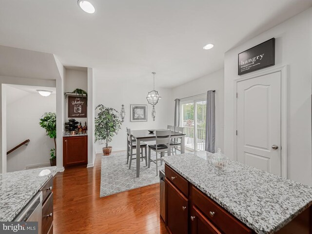 1420 Teagan Dr, Fredericksburg, VA 22408 - kitchen featuring wood finished floors, recessed lighting, reddish brown cabinets, decorative light fixtures, and a center island