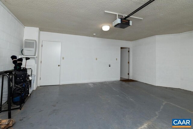 garage with concrete block wall and a garage door opener