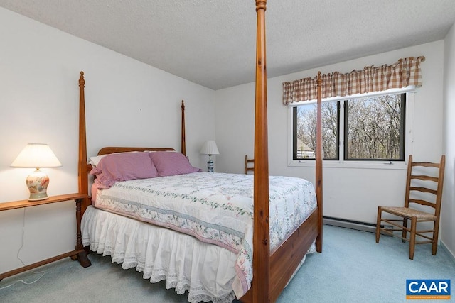 bedroom featuring a textured ceiling, baseboards, and carpet floors