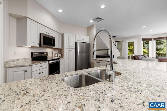 kitchen with a sink, stainless steel appliances, visible vents, recessed lighting, and white cabinets