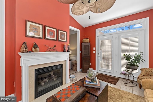 11135 Vanderbilt Cv, Spotsylvania, VA 22551 - tiled living area featuring vaulted ceiling, a ceiling fan, and a glass covered fireplace