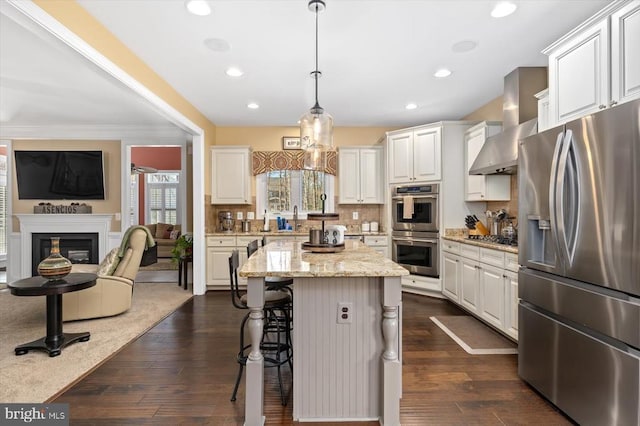 11135 Vanderbilt Cv, Spotsylvania, VA 22551 - kitchen with stainless steel appliances, white cabinetry, a breakfast bar, open floor plan, and recessed lighting
