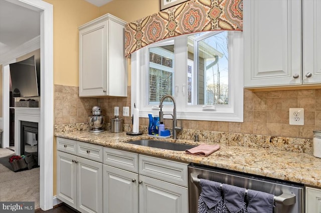 11135 Vanderbilt Cv, Spotsylvania, VA 22551 - kitchen featuring stainless steel dishwasher, a sink, white cabinets, tasteful backsplash, and ornamental molding