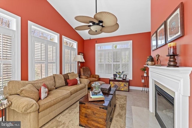 11135 Vanderbilt Cv, Spotsylvania, VA 22551 - living room featuring vaulted ceiling, ceiling fan, light tile patterned floors, a glass covered fireplace, and baseboards