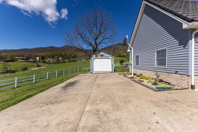 796 Battlecreek Rd, Stanley, VA 22851 - view of property exterior featuring fence, a mountain view, a garage, an outbuilding, and a lawn