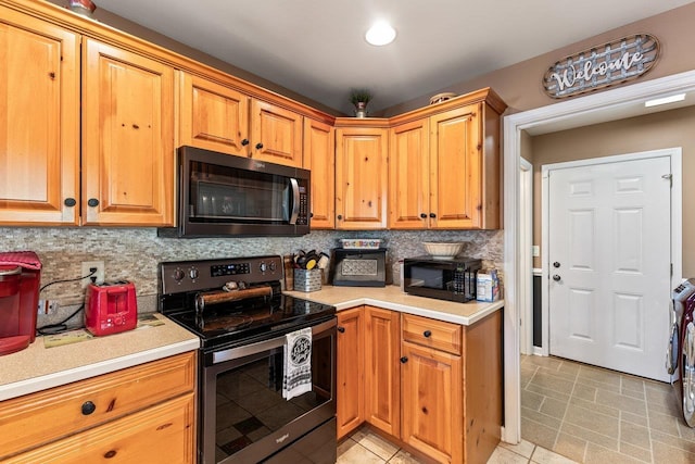 796 Battlecreek Rd, Stanley, VA 22851 - kitchen featuring backsplash, light countertops, stainless steel electric stove, and black microwave