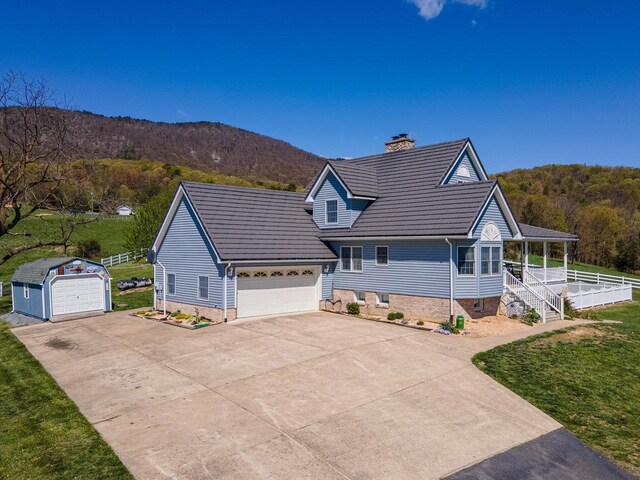 796 Battlecreek Rd, Stanley, VA 22851 - view of front of home featuring a chimney, an outbuilding, a mountain view, covered porch, and a front lawn
