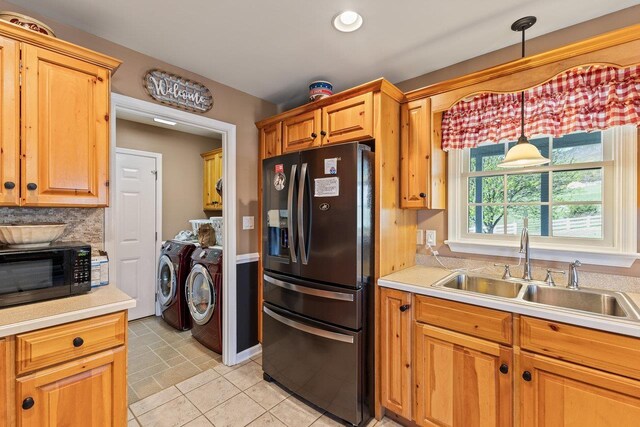 796 Battlecreek Rd, Stanley, VA 22851 - kitchen with washer and clothes dryer, a sink, black microwave, light countertops, and fridge with ice dispenser