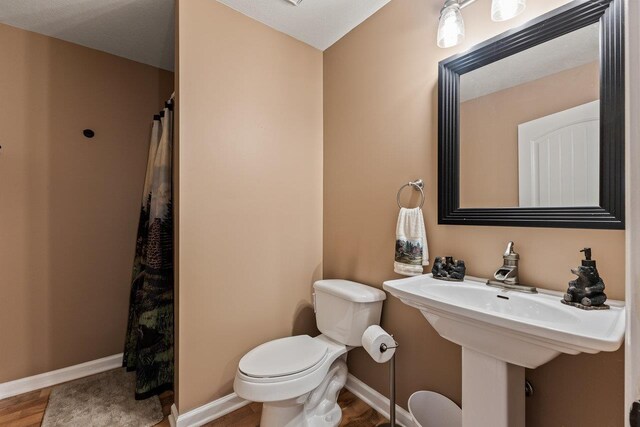 796 Battlecreek Rd, Stanley, VA 22851 - bathroom with toilet, curtained shower, wood finished floors, and baseboards