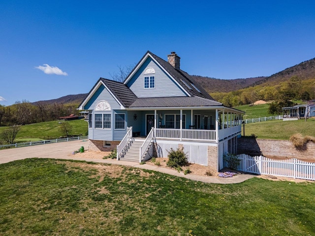 796 Battlecreek Rd, Stanley, VA 22851 - farmhouse-style home featuring a porch, a mountain view, a front lawn, and a chimney