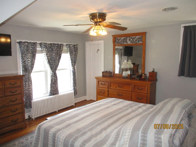 835 Rosser Ave, Waynesboro, VA 22980 - bedroom featuring radiator heating unit, wood finished floors, and a ceiling fan