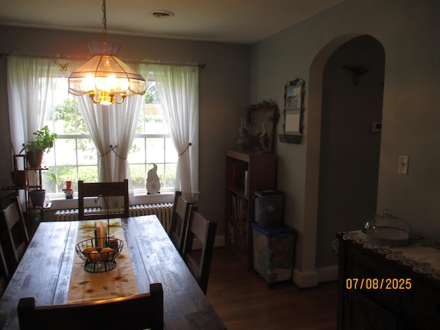 835 Rosser Ave, Waynesboro, VA 22980 - dining room with arched walkways, wood finished floors, a chandelier, and radiator heating unit