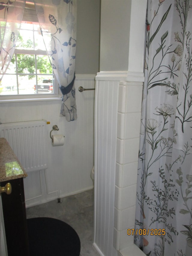 835 Rosser Ave, Waynesboro, VA 22980 - bathroom with radiator, vanity, a shower with curtain, and wainscoting