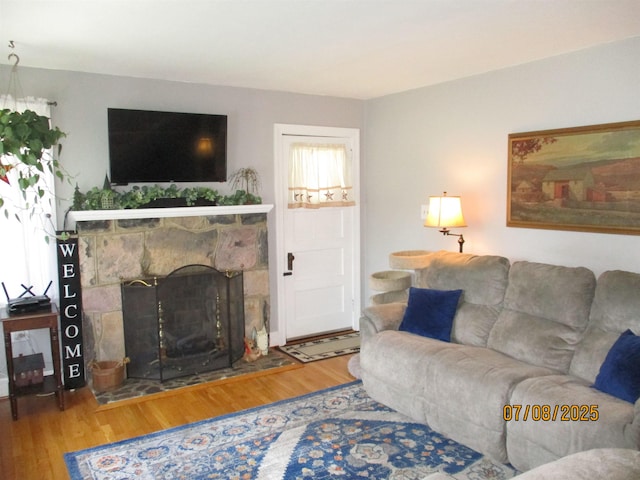 835 Rosser Ave, Waynesboro, VA 22980 - living area featuring wood finished floors, a stone fireplace, and healthy amount of natural light
