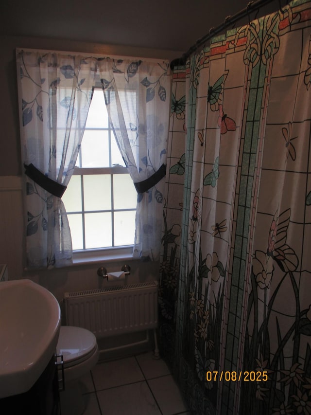 835 Rosser Ave, Waynesboro, VA 22980 - bathroom with radiator heating unit, tile patterned floors, and curtained shower