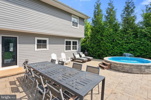  - view of patio / terrace featuring outdoor dining space and a pool