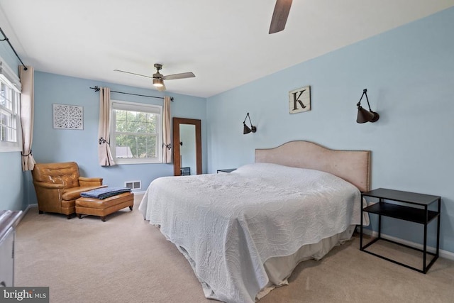  - carpeted bedroom with a ceiling fan
