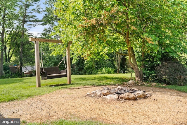 - view of grassy yard with a fire pit