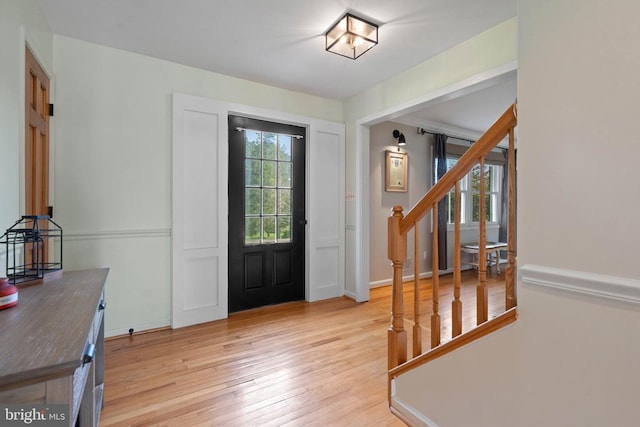  - entryway with light wood finished floors and stairs