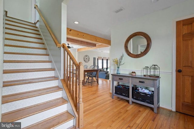  - staircase featuring wood finished floors and recessed lighting