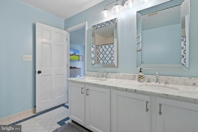  - full bathroom featuring double vanity and tile patterned floors