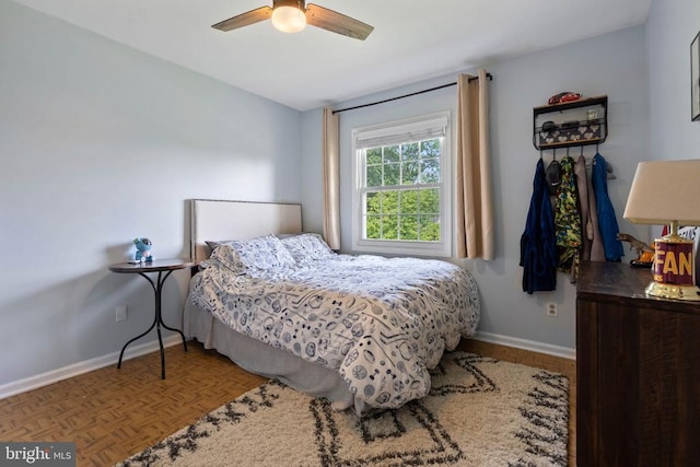 - bedroom featuring baseboards and a ceiling fan