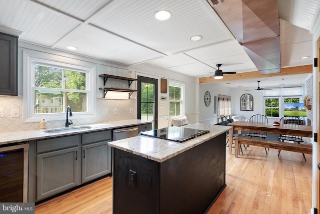  - kitchen featuring black electric stovetop, beverage cooler, gray cabinetry, a kitchen island, and ceiling fan