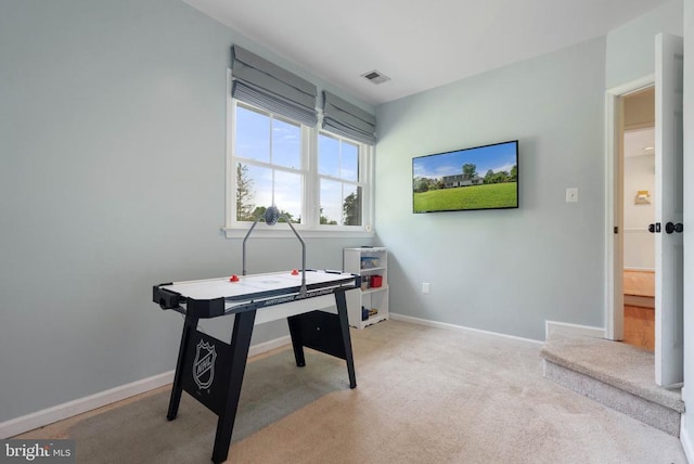  - rec room featuring light colored carpet and baseboards